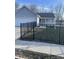 Charming single-story home with gray siding, a black metal fence and well-maintained lawn at 2027 E Werges Ave, Indianapolis, IN 46237