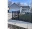 Charming single-story home with gray siding, a black metal fence and well-maintained lawn at 2027 E Werges Ave, Indianapolis, IN 46237