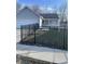 Charming single-story home with gray siding, a black metal fence and well-maintained lawn at 2027 E Werges Ave, Indianapolis, IN 46237