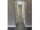 Hallway with a white door and grey wood-look floors at 2027 E Werges Ave, Indianapolis, IN 46237