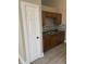 Well-lit kitchen featuring wooden cabinets, a stainless steel sink, and stylish backsplash at 2027 E Werges Ave, Indianapolis, IN 46237