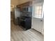 Modern kitchen featuring stainless steel appliances, dark cabinets, and gray wood-look tile flooring at 2027 E Werges Ave, Indianapolis, IN 46237