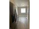 Kitchen view showcasing stainless steel refrigerator and new wood-look floors at 2027 E Werges Ave, Indianapolis, IN 46237