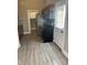 Modern kitchen featuring stainless steel appliances, dark cabinets, and gray wood-look tile flooring at 2027 E Werges Ave, Indianapolis, IN 46237