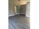 Spacious living room with neutral paint and gray wood-look tile flooring at 2027 E Werges Ave, Indianapolis, IN 46237