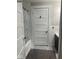 View of the bathroom with the door open to the bathtub and with a sink and cabinet also visible at 2122 George St, Anderson, IN 46016