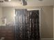 Bedroom with dark, decorative curtains and dresser with mirror and dresser at 2122 George St, Anderson, IN 46016
