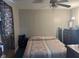 Bedroom with a patterned bedspread, ceiling fan, and window with curtains at 2122 George St, Anderson, IN 46016