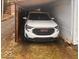 View of a white car parked inside a carport at 2122 George St, Anderson, IN 46016