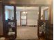 View of an open dining area with beaded curtains, a chandelier and dark wood trim at 2122 George St, Anderson, IN 46016