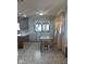 Kitchen/Dining Room area with windows and tile flooring with wooden chairs and table at 2122 George St, Anderson, IN 46016
