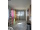 Open concept room with decorative curtains, and windows, with gray walls and flooring at 2122 George St, Anderson, IN 46016