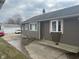 Home exterior with brown siding, white trim, and a concrete driveway at 2122 George St, Anderson, IN 46016