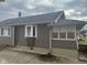 Angled view of the exterior of the home with vinyl siding, brick foundation, and various windows at 2122 George St, Anderson, IN 46016