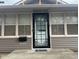 Close-up of the front door with a decorative metal screen and the house number 2122 at 2122 George St, Anderson, IN 46016