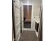 Hallway view into bedroom with wood-look floor, overhead lighting, and a bathroom to the side at 2122 George St, Anderson, IN 46016