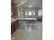 Eat-in kitchen showing tile floor, a kitchen table, and windows with decorative curtains at 2122 George St, Anderson, IN 46016