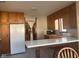 Charming kitchen with wooden cabinets, a breakfast bar and linoleum flooring at 2122 George St, Anderson, IN 46016