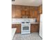 Traditional kitchen design featuring wood cabinets, white countertops, and a white gas range at 2122 George St, Anderson, IN 46016