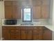 Traditional kitchen sink with wooden cabinets and standard lighting at 2122 George St, Anderson, IN 46016