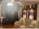 Bright living room with decorative curtains, entertainment center and comfortable seating at 2122 George St, Anderson, IN 46016
