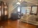 Spacious living room with hardwood floors, a ceiling fan, and an open doorway to the dining room at 2122 George St, Anderson, IN 46016