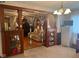 View of the living room with beaded curtain and a spacious design leading to another room at 2122 George St, Anderson, IN 46016