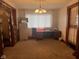 Neutral room with a chandelier, office desk, curtains, and carpet flooring at 2122 George St, Anderson, IN 46016