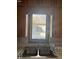 Stainless steel kitchen sink and fixtures beneath a window with an outside view at 2122 George St, Anderson, IN 46016