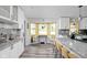 Spacious kitchen with white cabinets, granite counters, an eating space, and modern light fixtures at 2224 E Pleasant Run Parkway North Dr, Indianapolis, IN 46203