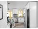 Bright, updated kitchen with white cabinetry, stainless steel appliances, and a view to the backyard at 2224 E Pleasant Run Parkway North Dr, Indianapolis, IN 46203