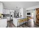 Modern kitchen featuring white cabinets, granite countertops, a breakfast bar, and stainless-steel appliances at 2224 E Pleasant Run Parkway North Dr, Indianapolis, IN 46203