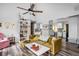 Open-concept living space with a modern couch, a bookshelf, and hardwood flooring at 2224 E Pleasant Run Parkway North Dr, Indianapolis, IN 46203