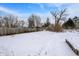 Expansive backyard, partially fenced and covered in fresh winter snow at 2401 N Olney St, Indianapolis, IN 46218