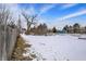 Large open backyard space with mature trees and a wood fence at 2401 N Olney St, Indianapolis, IN 46218