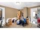 Bedroom filled with boxes and clutter, featuring beige walls and neutral carpeting at 2401 N Olney St, Indianapolis, IN 46218