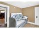 Guest room with a gray daybed featuring a blue and white Mickey Mouse themed bedspread at 2401 N Olney St, Indianapolis, IN 46218