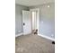 Cozy bedroom with neutral carpet and an open doorway to hall at 2401 N Olney St, Indianapolis, IN 46218