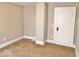 Bedroom with neutral walls, carpeting, and white door with black hardware at 2401 N Olney St, Indianapolis, IN 46218