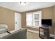 Small bedroom featuring a large window, a TV stand, and neutral walls and carpet at 2401 N Olney St, Indianapolis, IN 46218