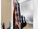 Angled closet space with clothing on hangers and extra storage space for musical instrument cases at 2401 N Olney St, Indianapolis, IN 46218