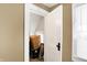Small closet with white door and a small window, containing storage boxes and household items at 2401 N Olney St, Indianapolis, IN 46218