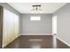 Bright dining room featuring sleek hardwood floors, stylish lighting, and neutral paint for versatile décor at 2401 N Olney St, Indianapolis, IN 46218