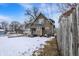 Two-story home with neutral siding, small front porch and snowy front yard at 2401 N Olney St, Indianapolis, IN 46218