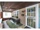 Inviting covered front porch featuring a decorative railing, wood ceiling, and a 'Welcome' mat at 2401 N Olney St, Indianapolis, IN 46218