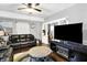 Comfortable living room featuring neutral walls, hardwood floors, and a decorative ceiling fan at 2401 N Olney St, Indianapolis, IN 46218
