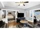 Living room showcasing hardwood floors and an easy flow into the dining area and bedroom at 2401 N Olney St, Indianapolis, IN 46218
