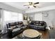 Comfortable living room featuring neutral walls, hardwood floors, and a decorative ceiling fan at 2401 N Olney St, Indianapolis, IN 46218