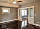 Inviting living room with gleaming hardwood floors and a decorative archway to adjacent room at 2401 N Olney St, Indianapolis, IN 46218