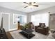 Inviting living room with ceiling fan, stylish furniture, and open access to a bright and airy room at 2401 N Olney St, Indianapolis, IN 46218